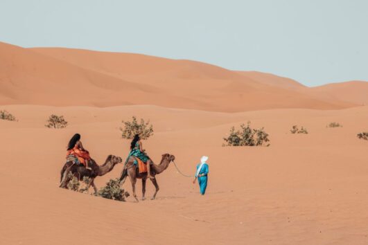 2 Females are enjoyin on Camel on 2 Days Tour From Fes to Merzouga