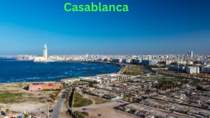 A panoramic view of Casablanca, Morocco, featuring the iconic Hassan II Mosque by the Atlantic Ocean, a key stop on the 9 Days Tour From Casablanca